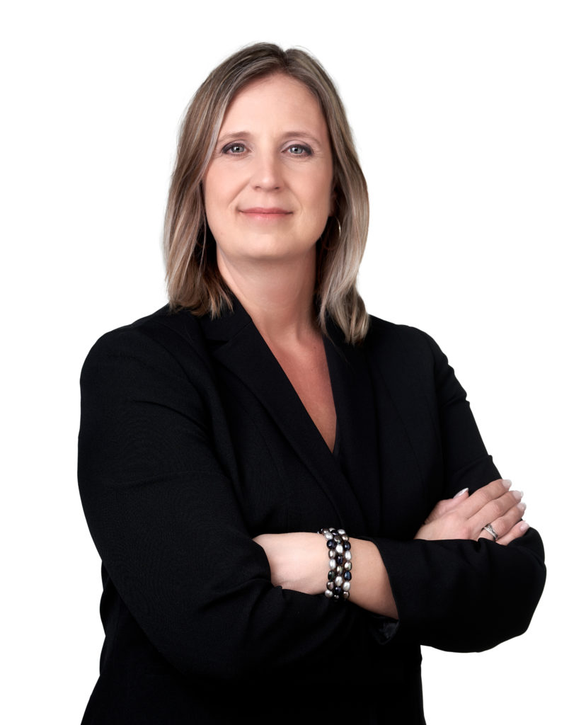 Maureen Terra posing for a professional portrait in front of a white background.